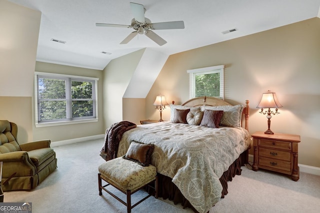 carpeted bedroom featuring vaulted ceiling, visible vents, and baseboards