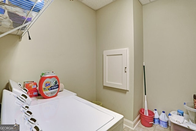 clothes washing area featuring laundry area, baseboards, and separate washer and dryer