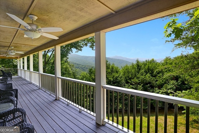 deck featuring a mountain view and a ceiling fan