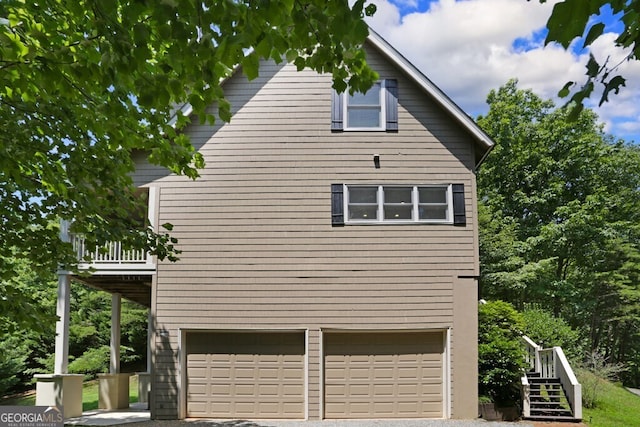 view of home's exterior with a balcony and an attached garage