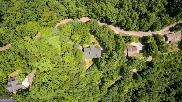 drone / aerial view featuring a wooded view