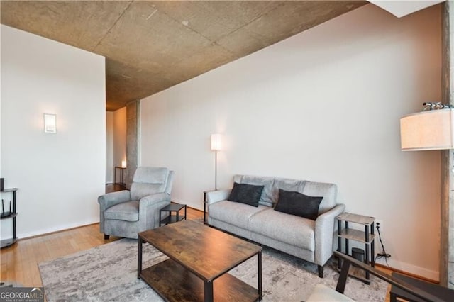 living room with baseboards and wood finished floors