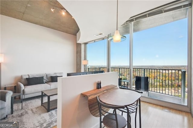 interior space featuring expansive windows, visible vents, and wood finished floors