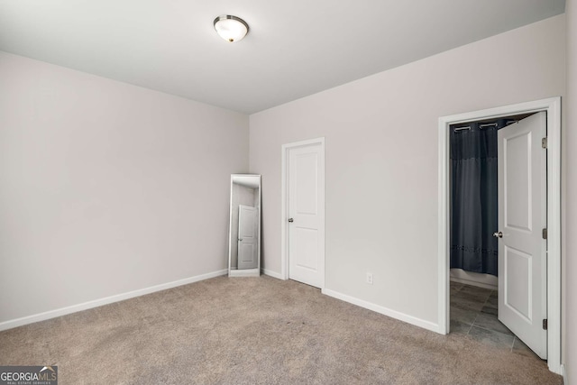 unfurnished bedroom with carpet and baseboards