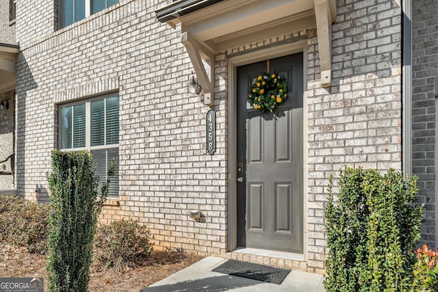 entrance to property with brick siding