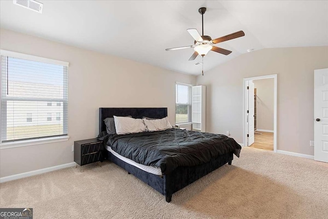 bedroom with light carpet, multiple windows, visible vents, and lofted ceiling