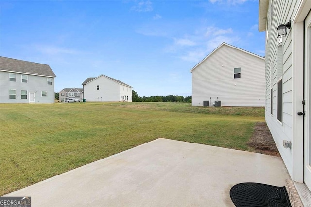 view of yard with central AC and a patio area