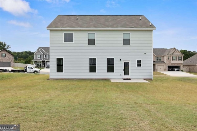 rear view of property featuring a patio and a lawn