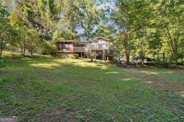 view of yard featuring a sunroom, stairway, and a wooden deck