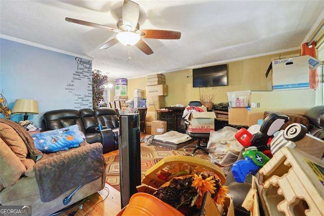 living room featuring ornamental molding, wood finished floors, and a ceiling fan