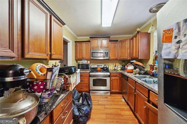 kitchen featuring appliances with stainless steel finishes, brown cabinets, ornamental molding, light wood-style floors, and a sink