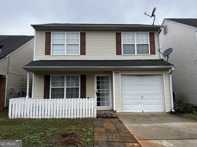 traditional home with concrete driveway and an attached garage