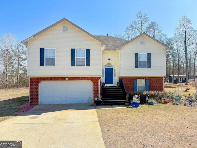 bi-level home featuring concrete driveway, brick siding, and an attached garage