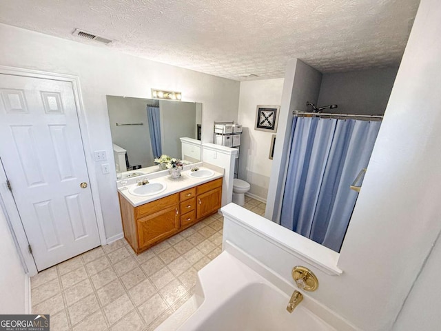 bathroom with visible vents, a shower with shower curtain, a sink, and toilet