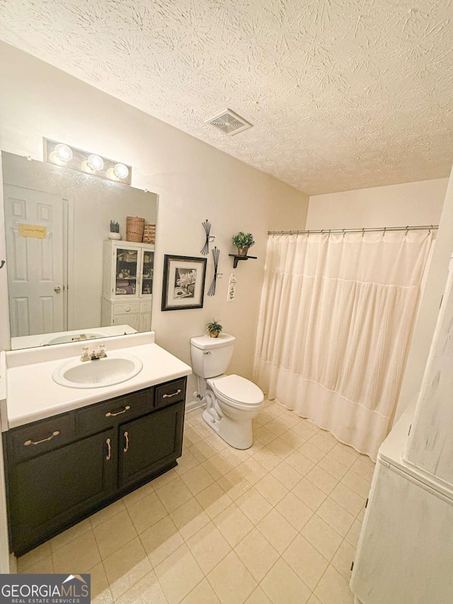 full bathroom featuring visible vents, toilet, tile patterned flooring, a textured ceiling, and vanity