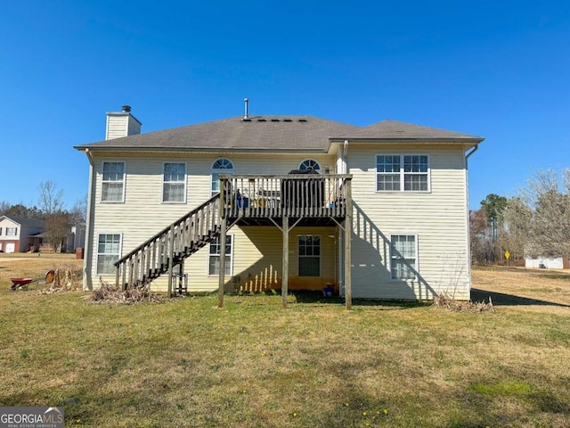 back of property featuring a wooden deck, stairs, a chimney, and a yard