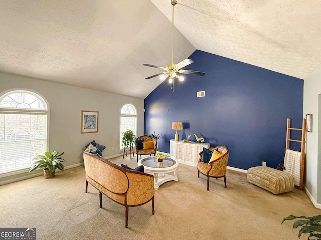 sitting room featuring ceiling fan, carpet floors, lofted ceiling, and visible vents