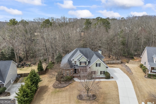 drone / aerial view featuring a forest view