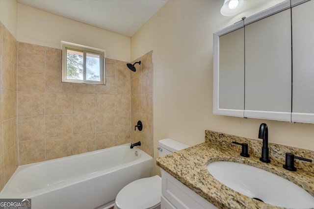 bathroom featuring washtub / shower combination, vanity, and toilet