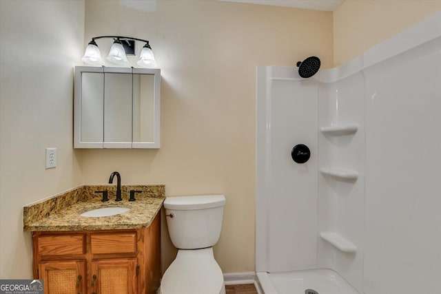 full bathroom featuring toilet, a shower, and vanity