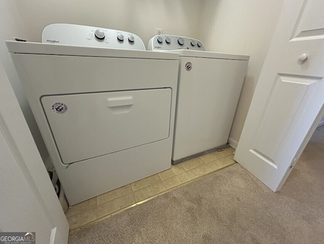 laundry room featuring washer and dryer, laundry area, and light colored carpet