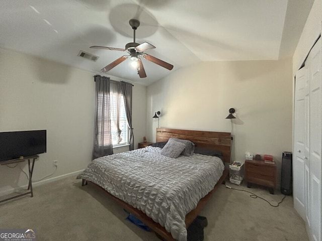 carpeted bedroom featuring baseboards, visible vents, lofted ceiling, ceiling fan, and a closet