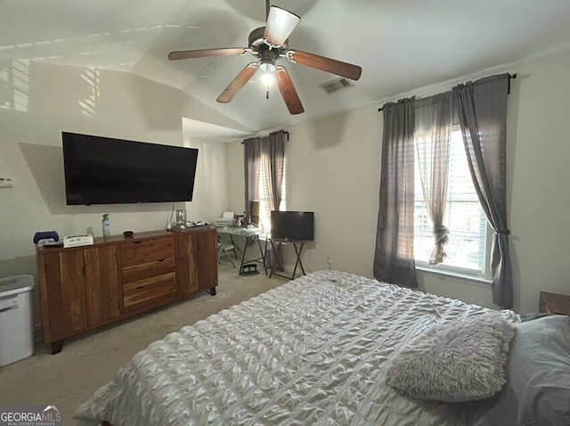 bedroom with ceiling fan, visible vents, vaulted ceiling, and light colored carpet