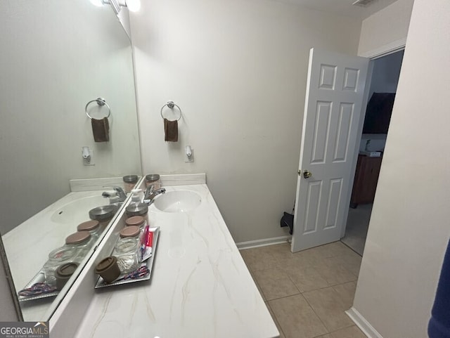 bathroom featuring vanity, baseboards, and tile patterned floors