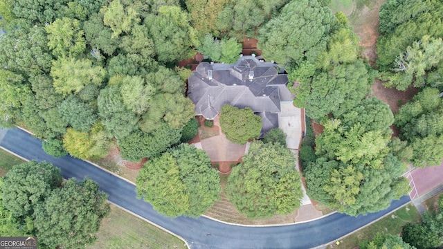 birds eye view of property with a wooded view