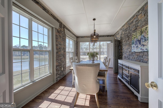 dining space with dark wood-style floors and ornamental molding