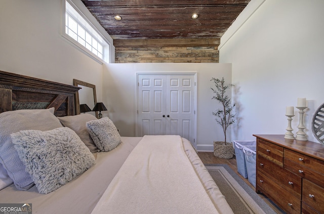 bedroom with dark wood finished floors, recessed lighting, a closet, a high ceiling, and wood ceiling