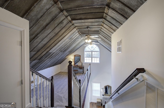 stairway with vaulted ceiling, visible vents, and ceiling fan