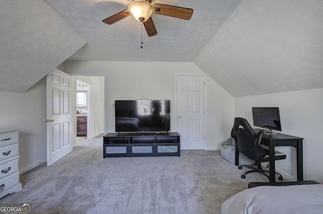 bedroom with vaulted ceiling, baseboards, carpet floors, and a textured ceiling