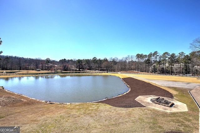 view of water feature with a fire pit