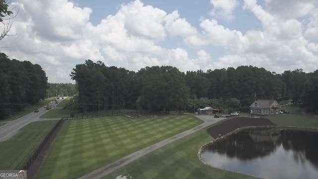 view of home's community featuring a lawn and a wooded view