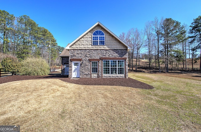 rear view of house featuring a lawn