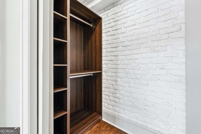 walk in closet featuring dark wood-style floors