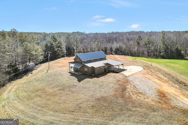 birds eye view of property with a view of trees