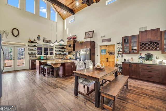 dining room featuring dark wood-style flooring, french doors, visible vents, wood ceiling, and beamed ceiling