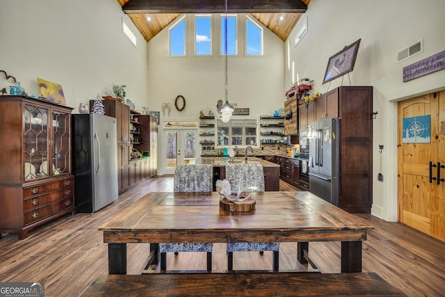 dining area with french doors, visible vents, dark wood finished floors, and lofted ceiling with beams