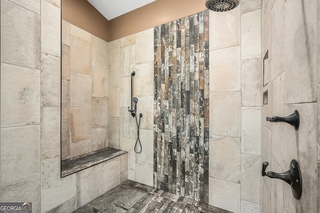 bathroom with a tile shower