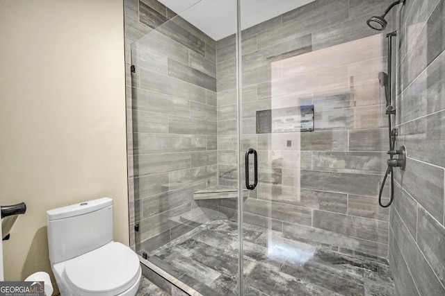 full bathroom with toilet and a shower stall