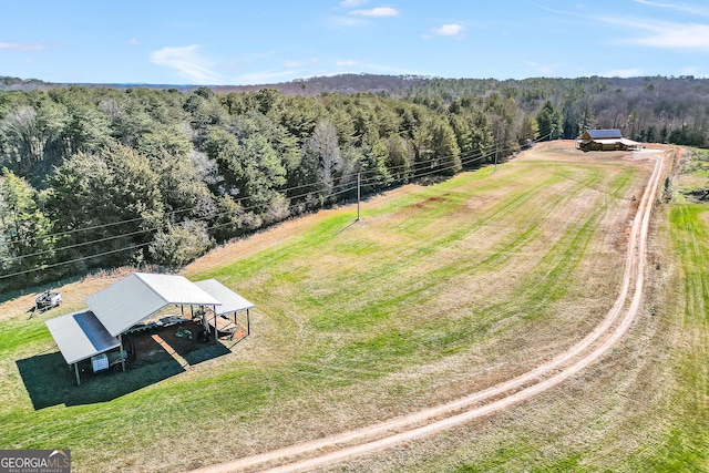 aerial view with a rural view and a wooded view