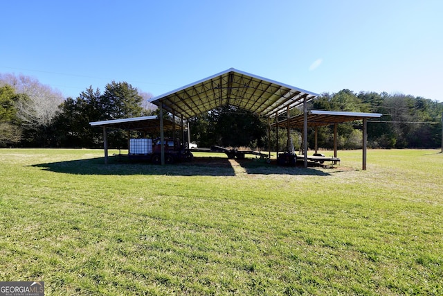 view of property's community featuring a lawn and a carport