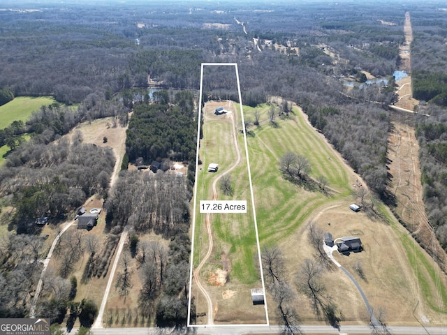 drone / aerial view featuring a wooded view