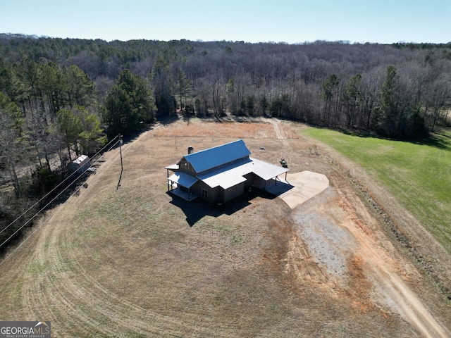 birds eye view of property featuring a forest view