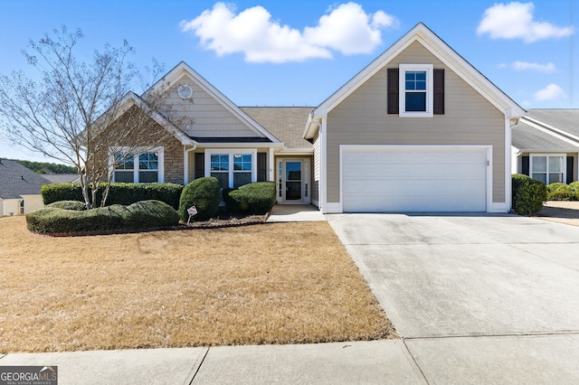 view of front facade with stone siding, a front yard, and concrete driveway