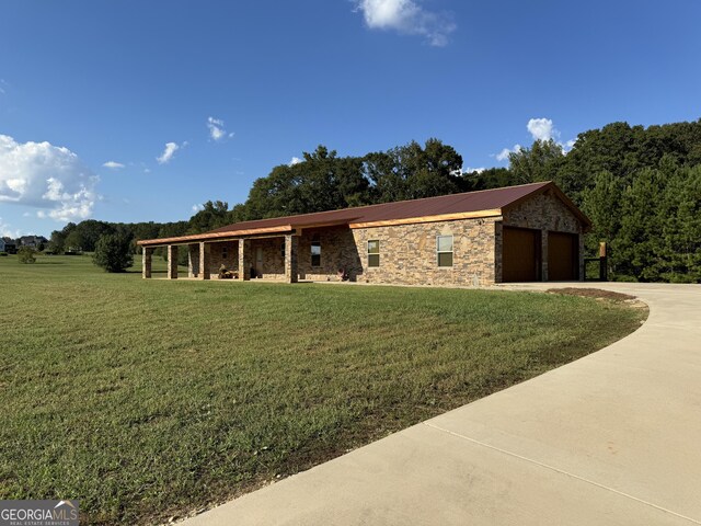 view of front of property with metal roof, stone siding, and a front lawn