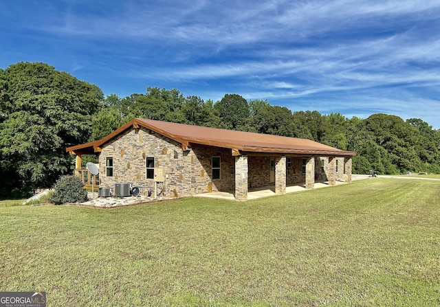 view of property exterior featuring stone siding, a yard, a patio, and central AC unit