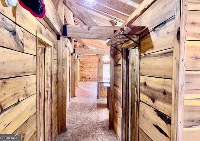 corridor with wood ceiling, beamed ceiling, and wooden walls